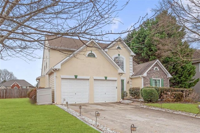 view of front of house featuring a front lawn and a garage