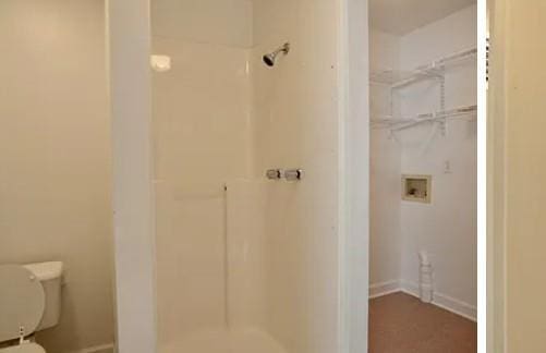 bathroom with toilet and walk in shower