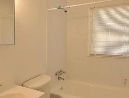 bathroom with shower / washtub combination, vanity, and toilet