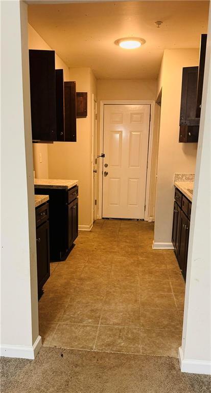 kitchen featuring light countertops and baseboards