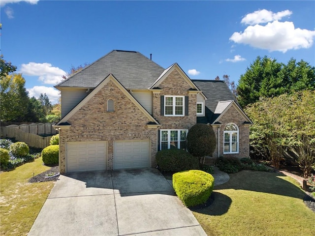 front facade featuring a garage and a front lawn