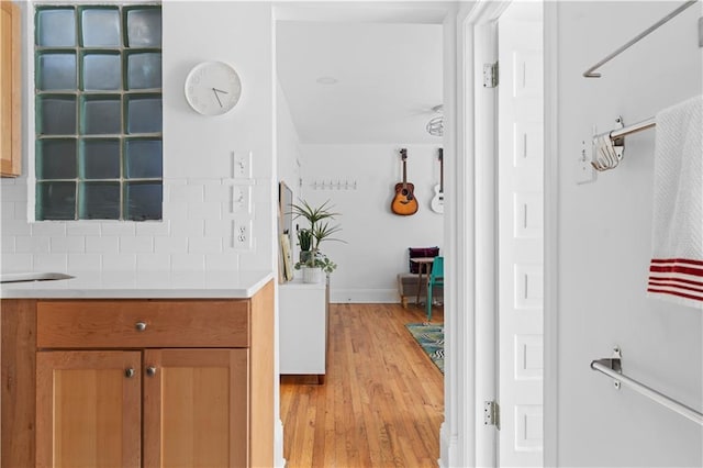 bathroom with tasteful backsplash and wood-type flooring