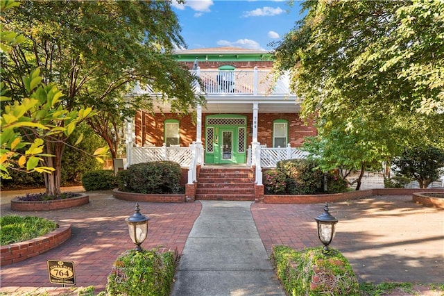 view of front of home with a porch and a balcony