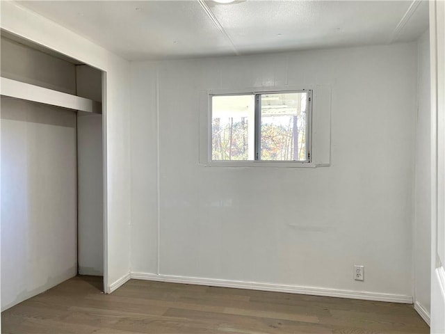 unfurnished bedroom featuring dark hardwood / wood-style floors