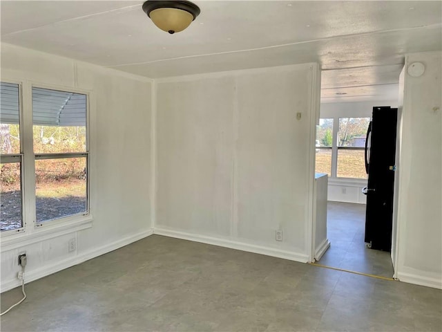 unfurnished room featuring concrete flooring