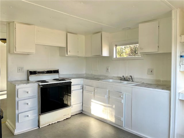 kitchen featuring sink, white cabinets, and white electric stove