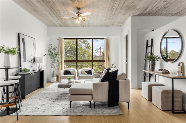 living room with ceiling fan and light hardwood / wood-style flooring