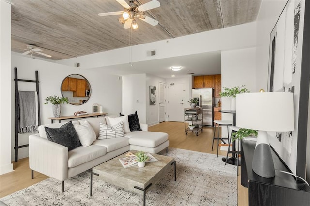 living room featuring ceiling fan and light wood-type flooring