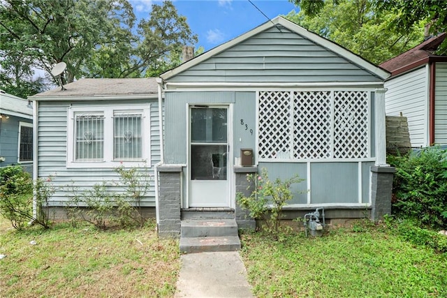 bungalow-style home featuring entry steps and a front yard