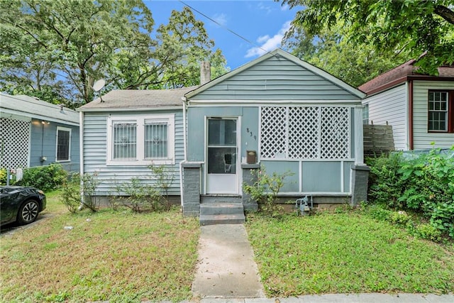 bungalow with entry steps and a front yard