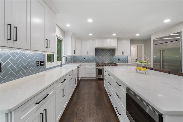 660 Willow Knoll Dr SE, Marietta, GA 30067 - kitchen featuring built in appliances, dark wood-style flooring, white cabinets, tasteful backsplash, and recessed lighting