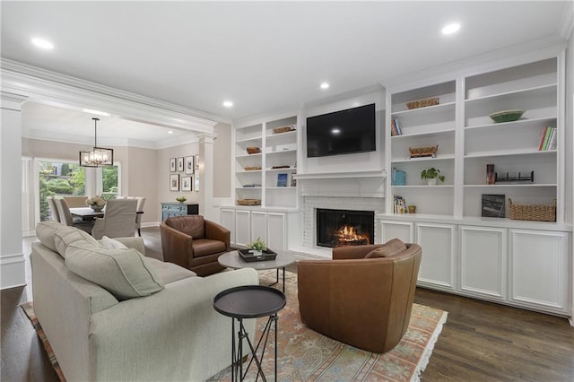 660 Willow Knoll Dr SE, Marietta, GA 30067 - living area with dark wood-style floors, ornamental molding, a brick fireplace, a chandelier, and recessed lighting