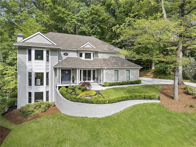 660 Willow Knoll Dr SE, Marietta, GA 30067 - view of front of property featuring a chimney, stucco siding, covered porch, a front yard, and roof with shingles
