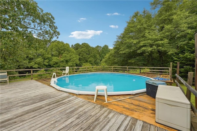 view of swimming pool with a wooden deck