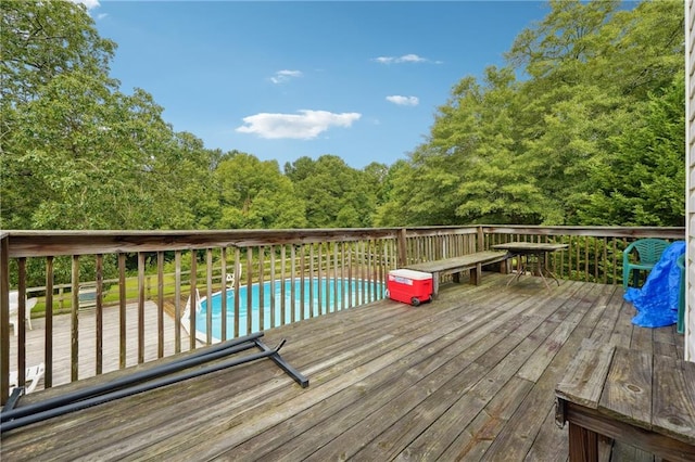 wooden deck featuring a fenced in pool