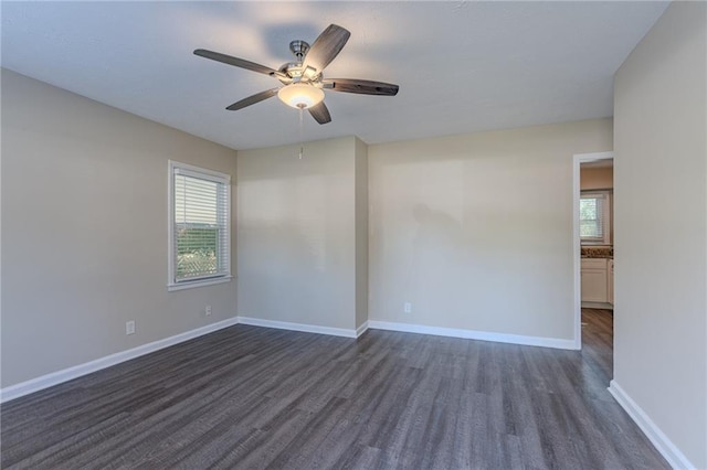 spare room featuring dark hardwood / wood-style floors, a wealth of natural light, and ceiling fan