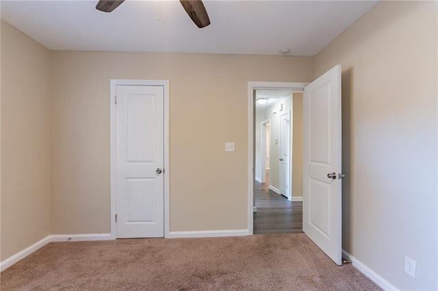 unfurnished bedroom with ceiling fan and carpet