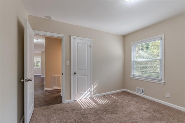 carpeted empty room featuring a healthy amount of sunlight