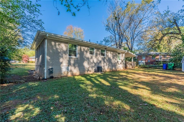 rear view of property featuring a lawn