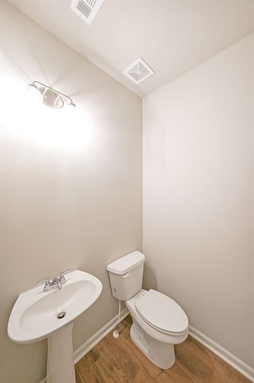 175 W Woods Dr, Dahlonega, GA 30533 - bathroom with wood finished floors, toilet, and baseboards