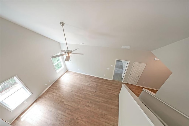 175 W Woods Dr, Dahlonega, GA 30533 - unfurnished living room featuring vaulted ceiling, light wood-type flooring, ceiling fan, and baseboards