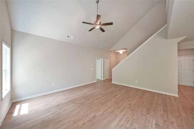 175 W Woods Dr, Dahlonega, GA 30533 - unfurnished living room with high vaulted ceiling, a ceiling fan, stairway, light wood-type flooring, and baseboards