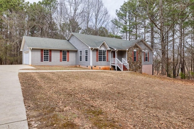 ranch-style house with a shingled roof, crawl space, a garage, and concrete driveway