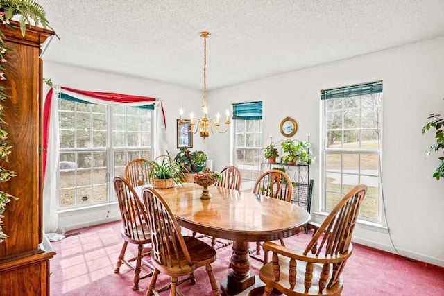 dining space with plenty of natural light, a chandelier, and a textured ceiling