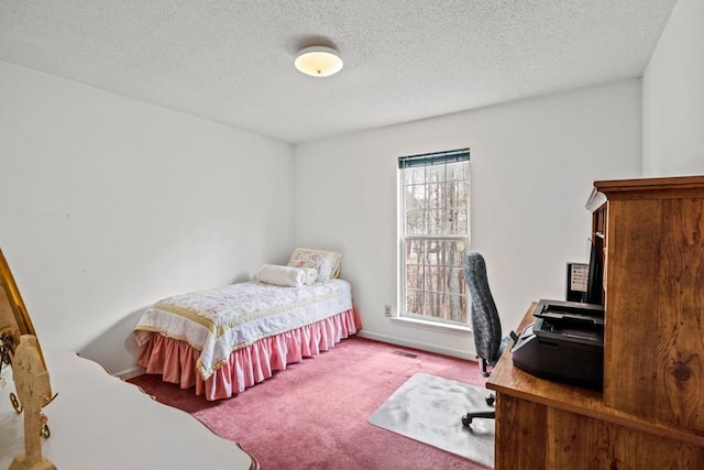 bedroom with baseboards, a textured ceiling, visible vents, and carpet flooring