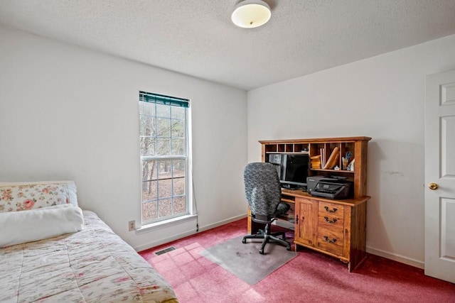 carpeted bedroom with a textured ceiling, visible vents, and baseboards