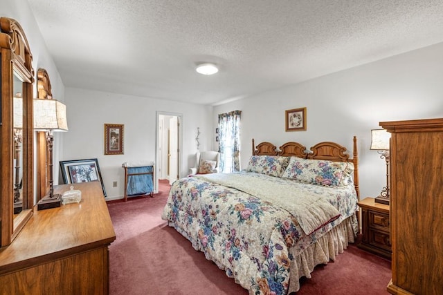 bedroom with carpet floors and a textured ceiling