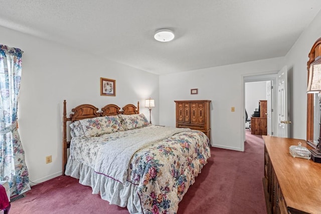 bedroom with baseboards and dark carpet