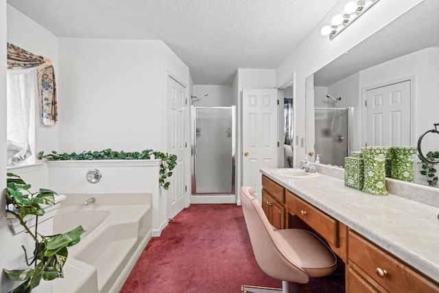 full bath featuring a garden tub, a textured ceiling, a shower stall, and vanity