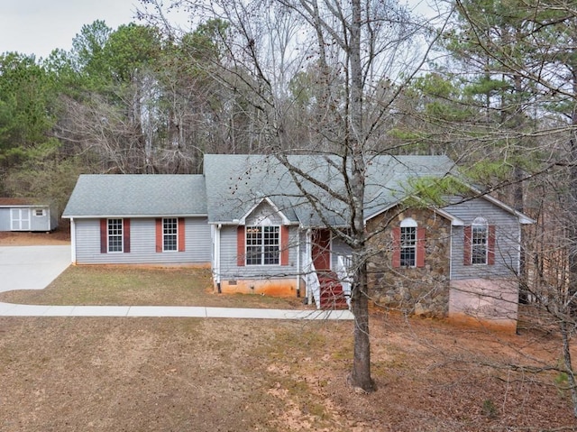 ranch-style house with stone siding, a front lawn, crawl space, and a shingled roof