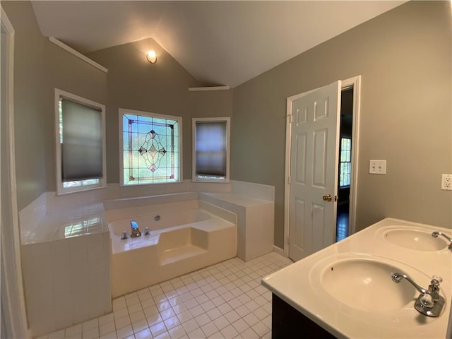 bathroom featuring vanity, lofted ceiling, tiled bath, and tile patterned floors