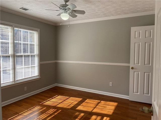 spare room with ornamental molding, dark hardwood / wood-style floors, a textured ceiling, and ceiling fan