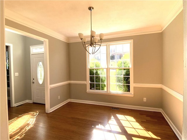 foyer entrance with crown molding, an inviting chandelier, and dark hardwood / wood-style flooring