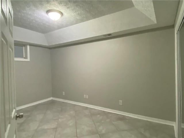 basement featuring a textured ceiling