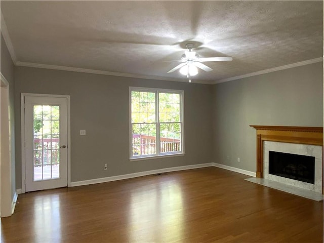 unfurnished living room with ceiling fan, ornamental molding, and dark hardwood / wood-style flooring