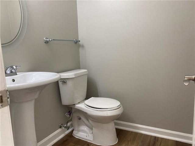 bathroom with sink, hardwood / wood-style flooring, and toilet