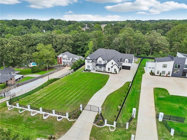 birds eye view of property featuring a view of trees