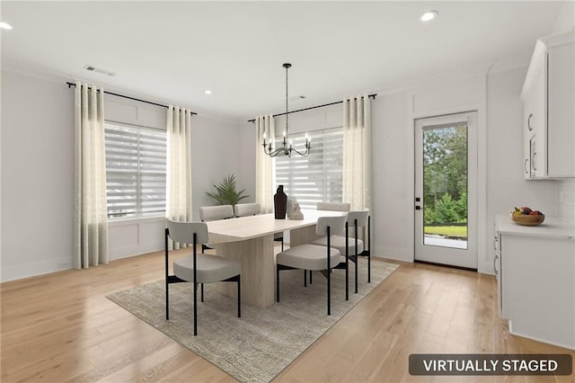dining room featuring recessed lighting, a chandelier, ornamental molding, and light wood finished floors