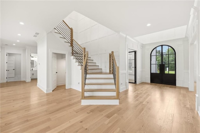 foyer entrance with visible vents, recessed lighting, stairs, french doors, and light wood-type flooring