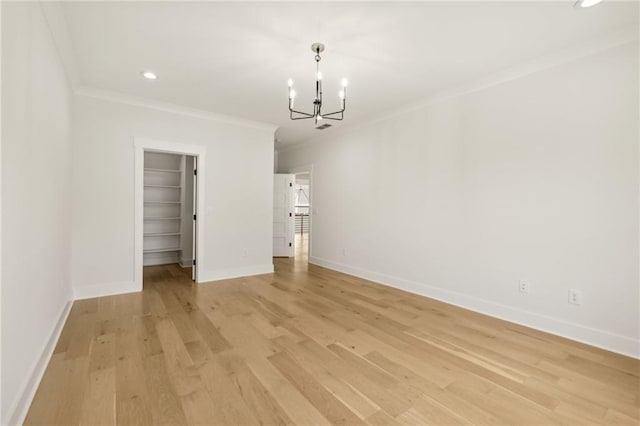 interior space with light wood-style flooring, ornamental molding, recessed lighting, an inviting chandelier, and baseboards