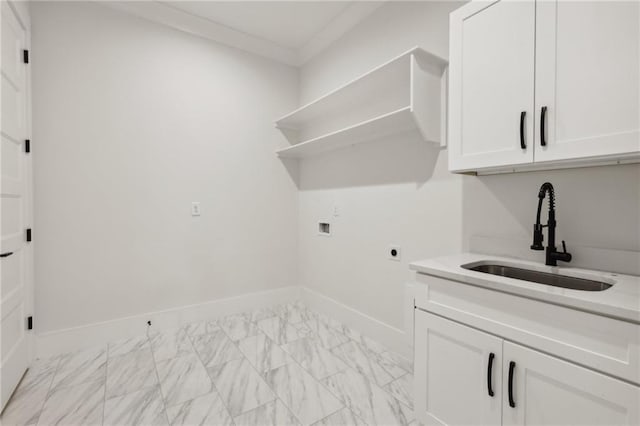 laundry area featuring baseboards, washer hookup, cabinet space, electric dryer hookup, and a sink