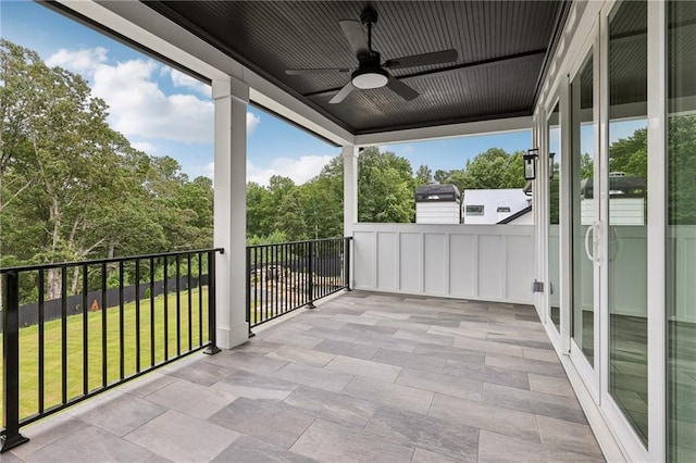 view of patio with a balcony and a ceiling fan