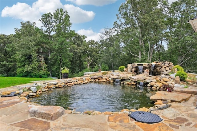 property view of water with a garden pond