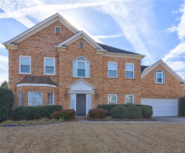 view of front of property featuring a garage, driveway, brick siding, and a front lawn