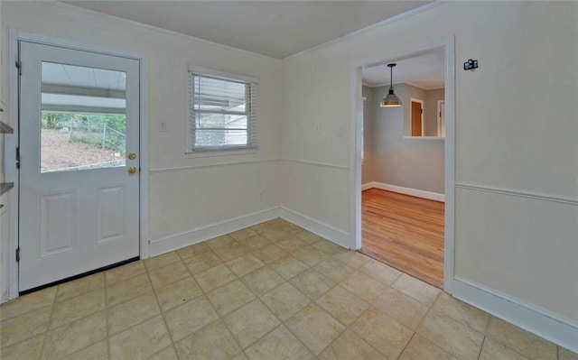 interior space featuring baseboards and ornamental molding
