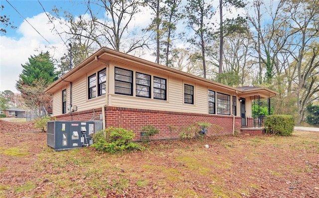 view of side of property featuring brick siding